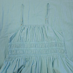 Close-up of a light blue fabric with pleated details