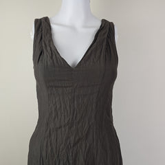 Dark gray dress on a mannequin against a plain background