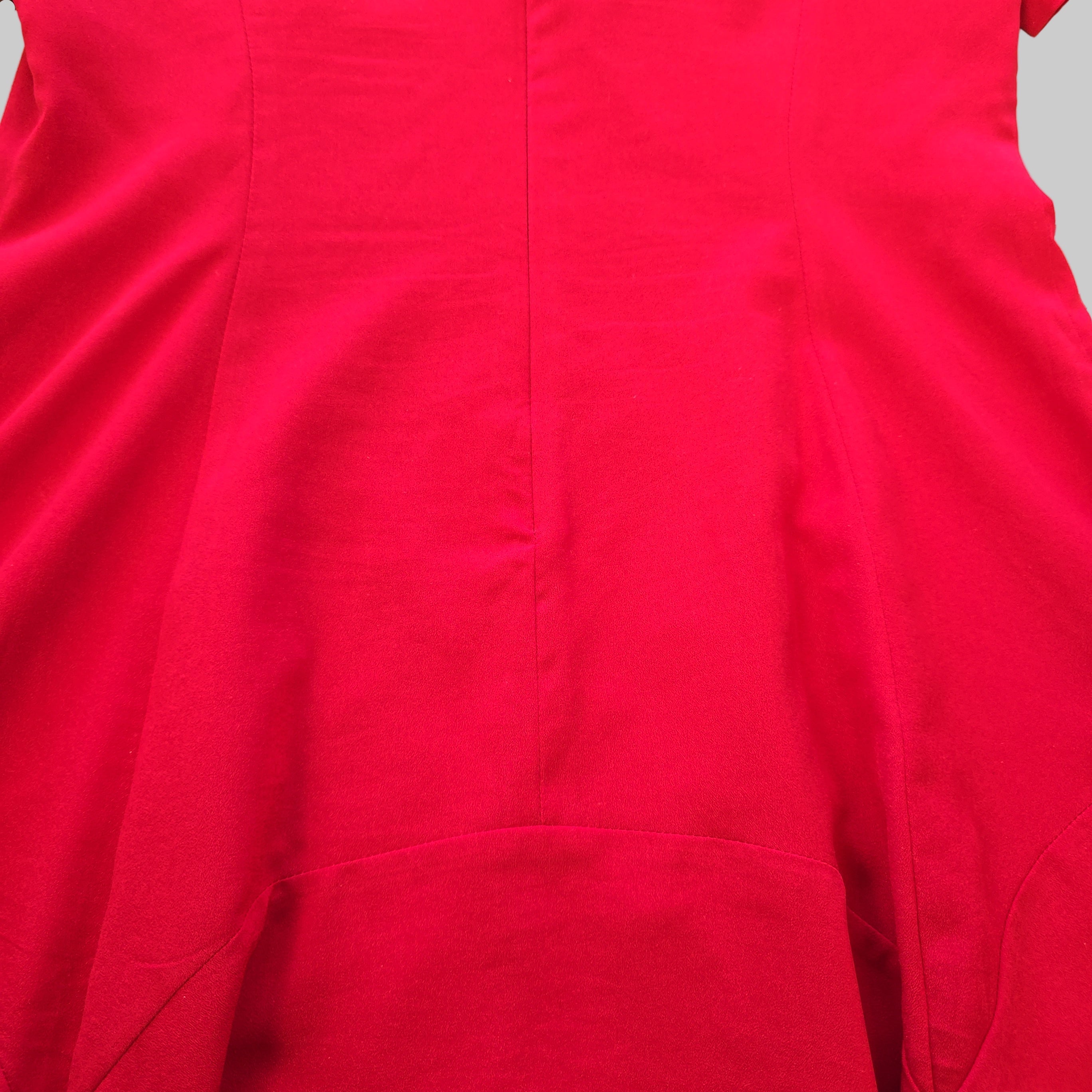 Close-up of a red garment with a focus on texture and color.