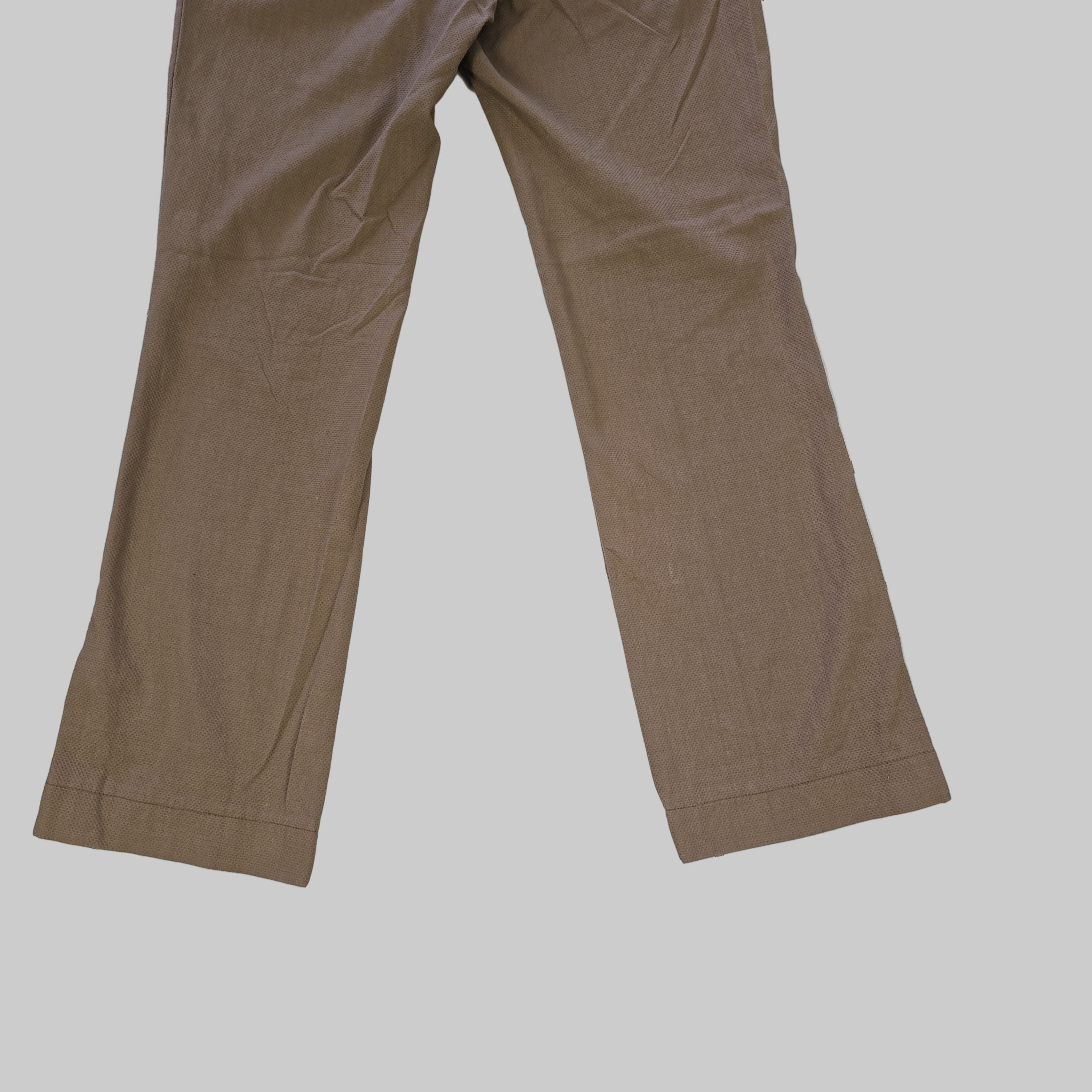 Brown pants on a tiled floor