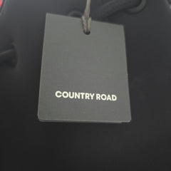 Gray tag with 'COUNTRY ROAD' text on a black background