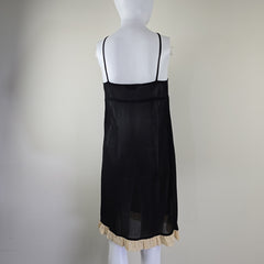 Black sheer skirt with ruffled hem on a mannequin against a plain background