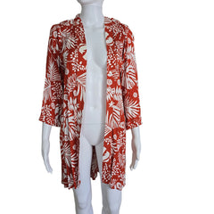 Orange and white palm patterned robe on a light background