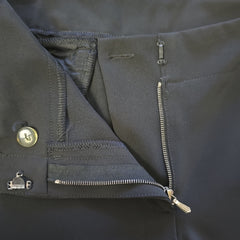Close-up of a dark pants with zippers and buttons