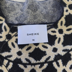Close-up of a patterned fabric with a 'SHEIKE' label and size tag.