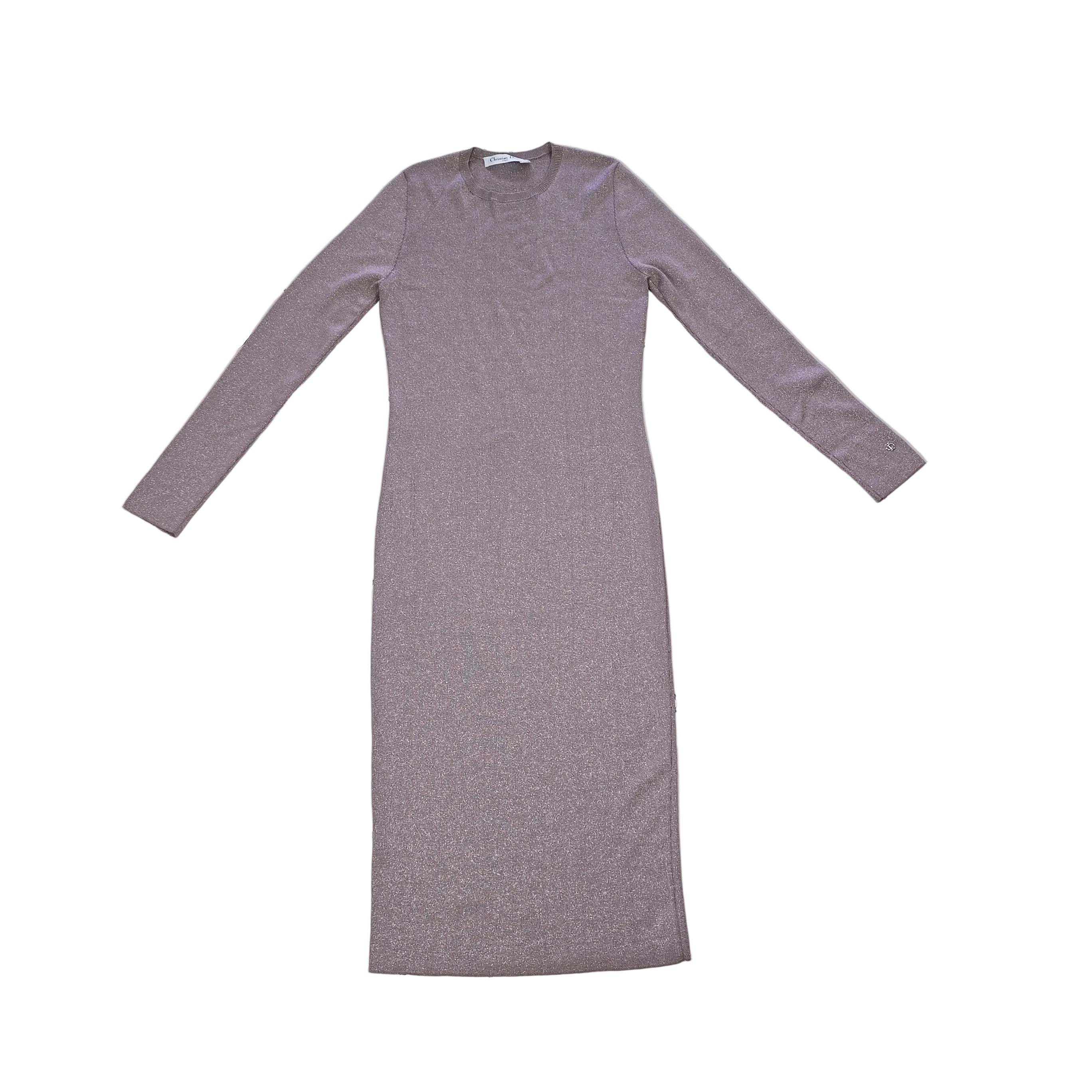 Plumb coloured dress with silver details on a light background