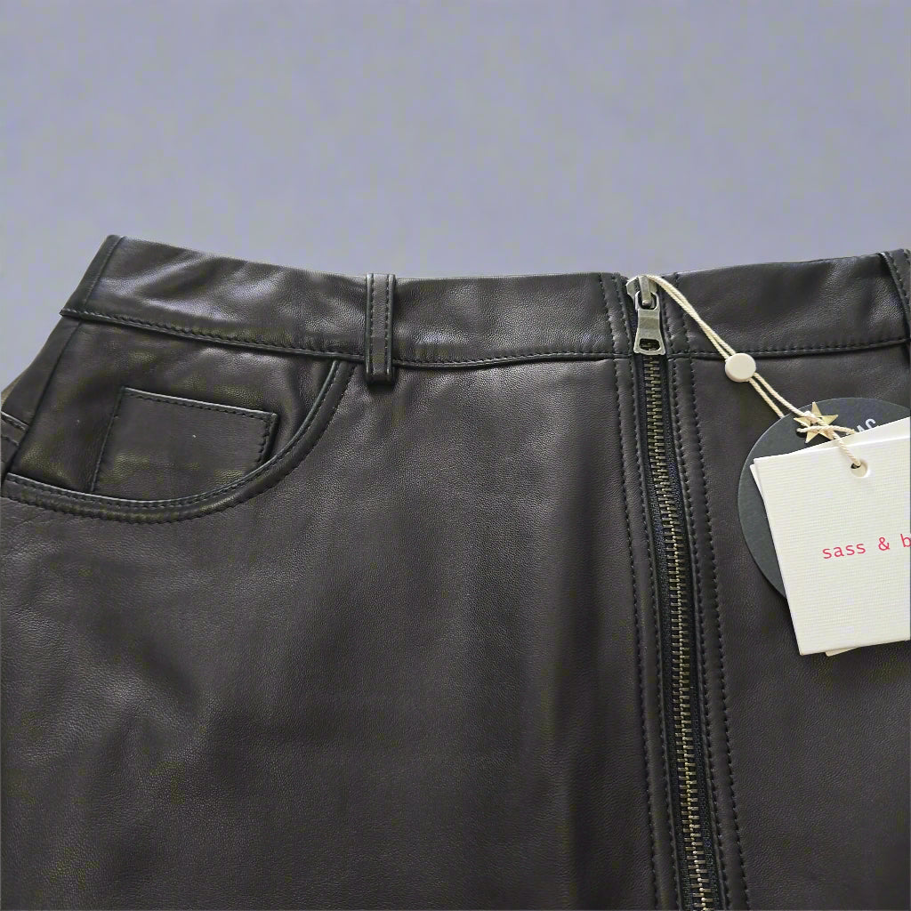 Black leather bag with a visible brand tag on a light background