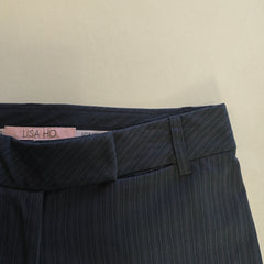 Dark blue pants with a visible brand label on a beige background