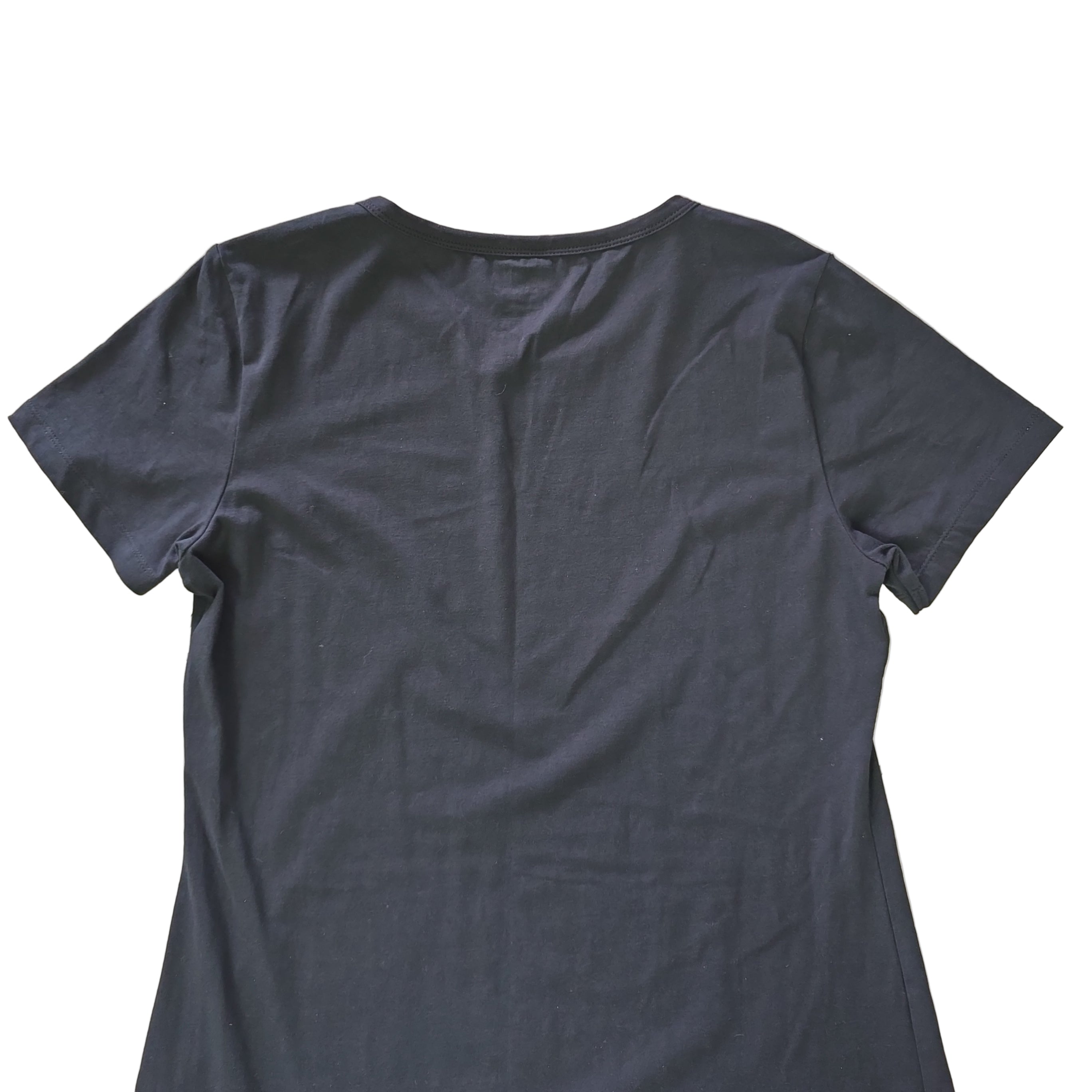 Black t-shirt dress with DKNY logo on a light background