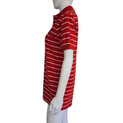 Mannequin wearing a red and white striped garment on a plain background