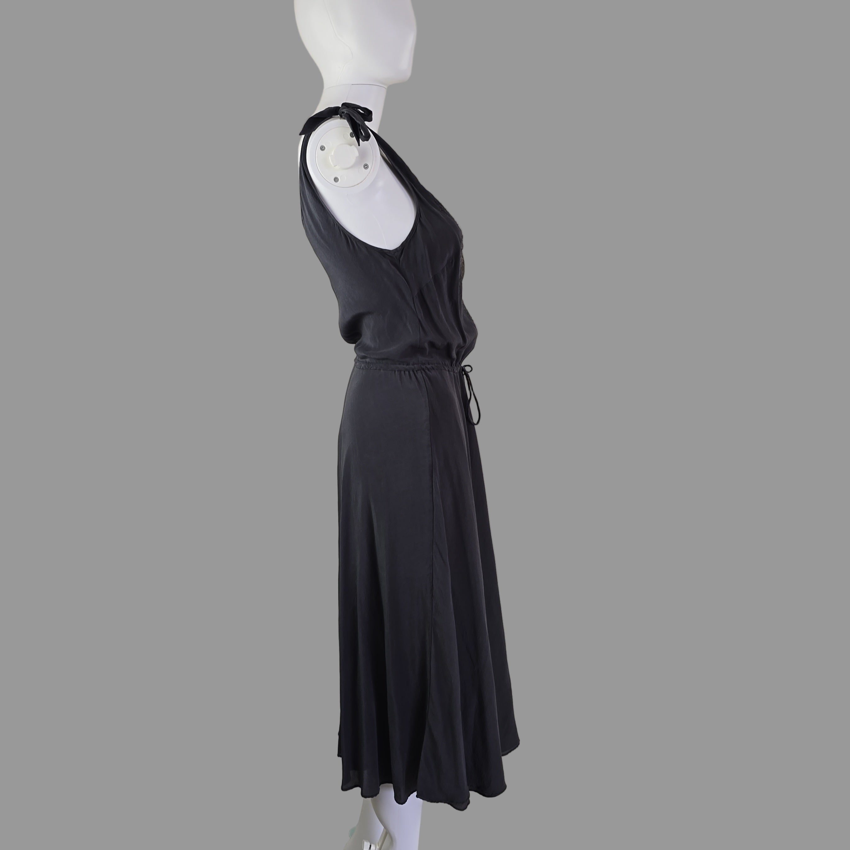 Grey dress on a mannequin against a white wall