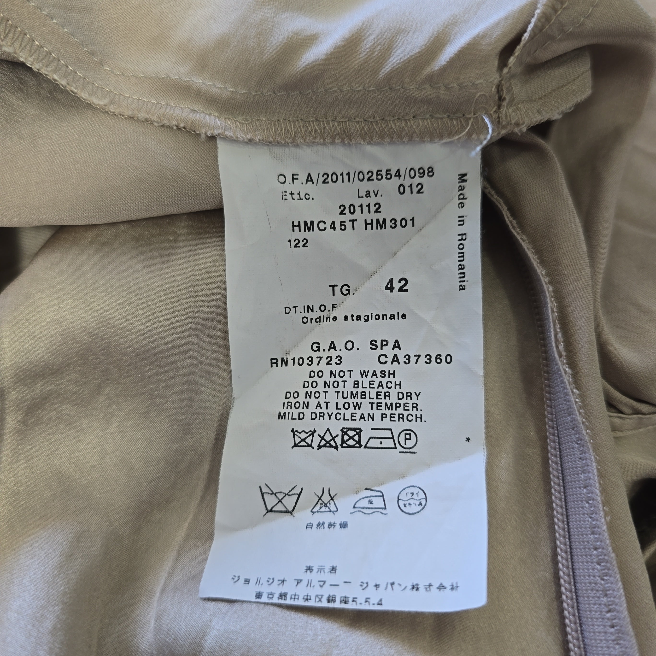 Clothing label on a beige fabric background