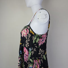 Black floral-patterned top on a light background