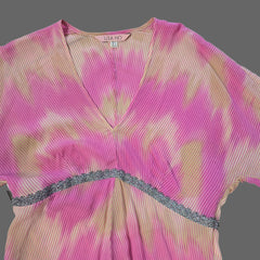 Pink top with a silver trim on a light gray background