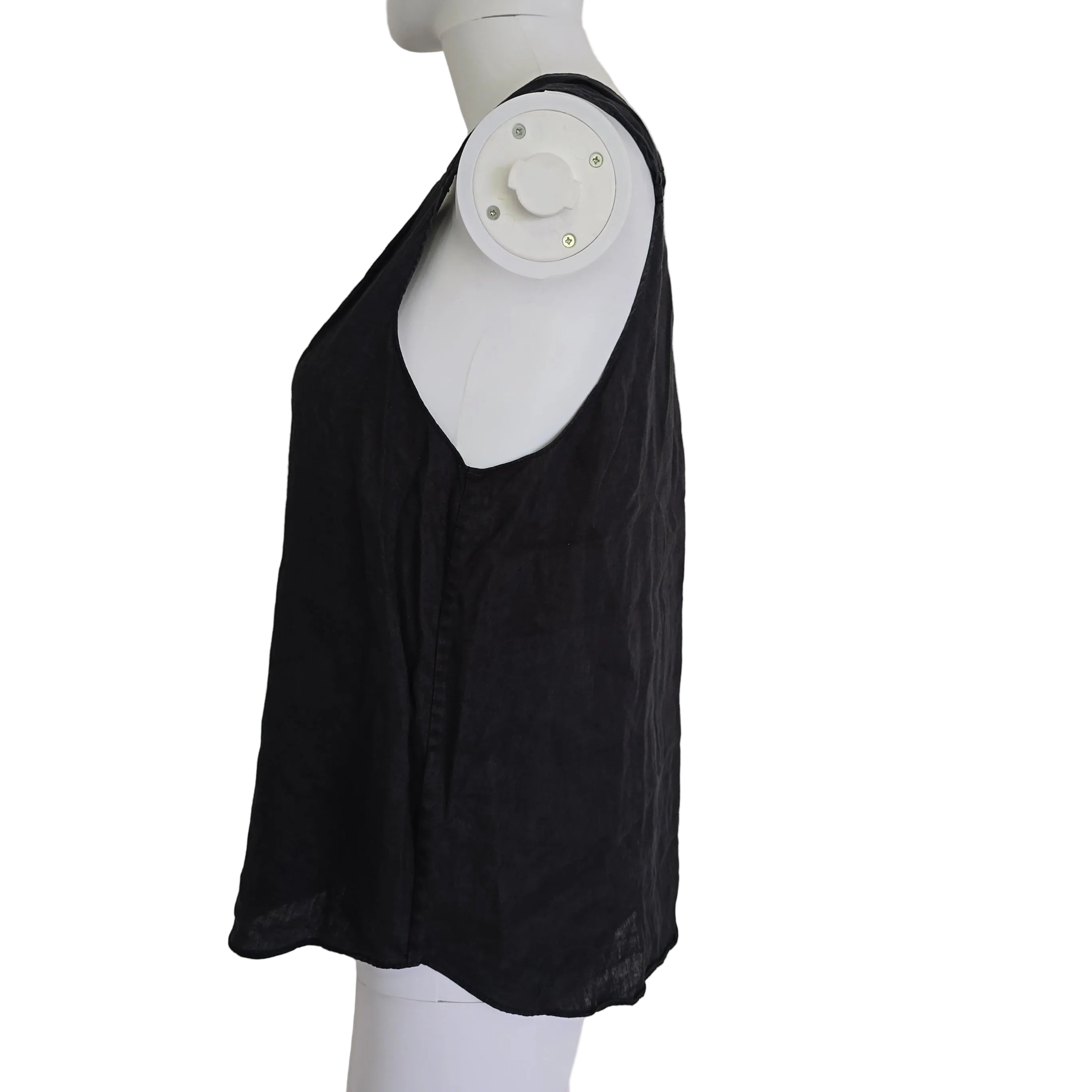 Black garment on a white mannequin against a light background