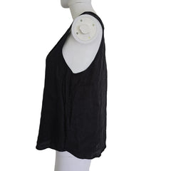 Black garment on a white mannequin against a light background
