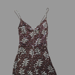 Brown and white patterned dress on a tiled floor