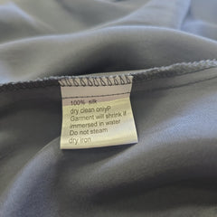 Fabric with a care label on a gray background