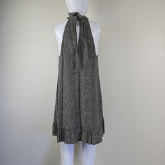 Grey and white spotted patterned dress on a light background