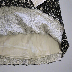 Black lace garment on a tiled floor