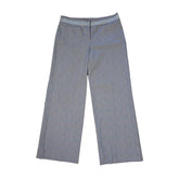 Two pairs of blue checkered pants on a tiled floor