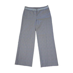 Two pairs of blue checkered pants on a tiled floor