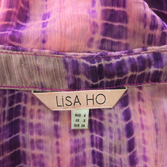 Close-up of a purple and pink patterned fabric with a Lisa Ho label.