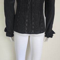Black long sleeved button up top with black lace details on a light background