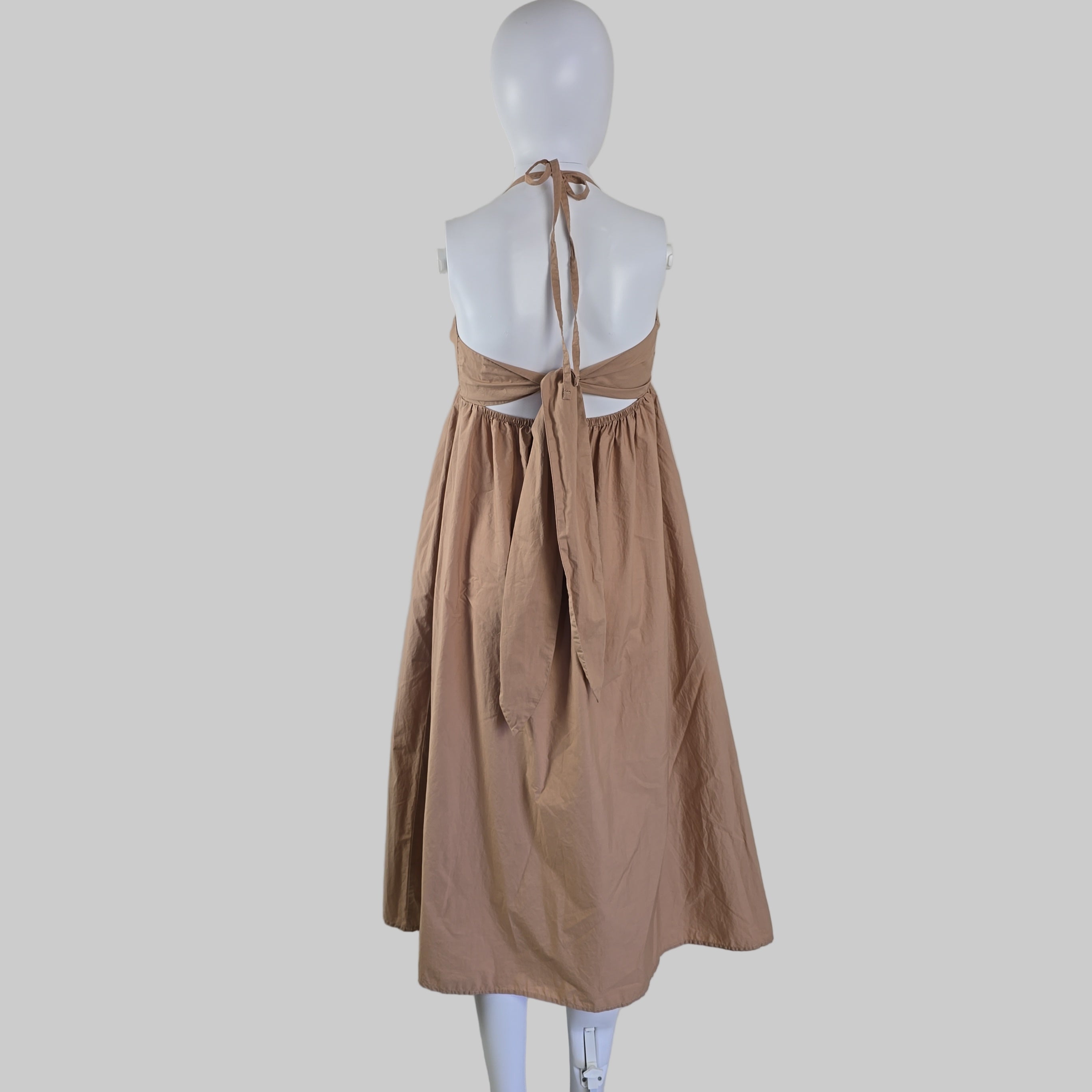 Brown dress on a mannequin against a white background