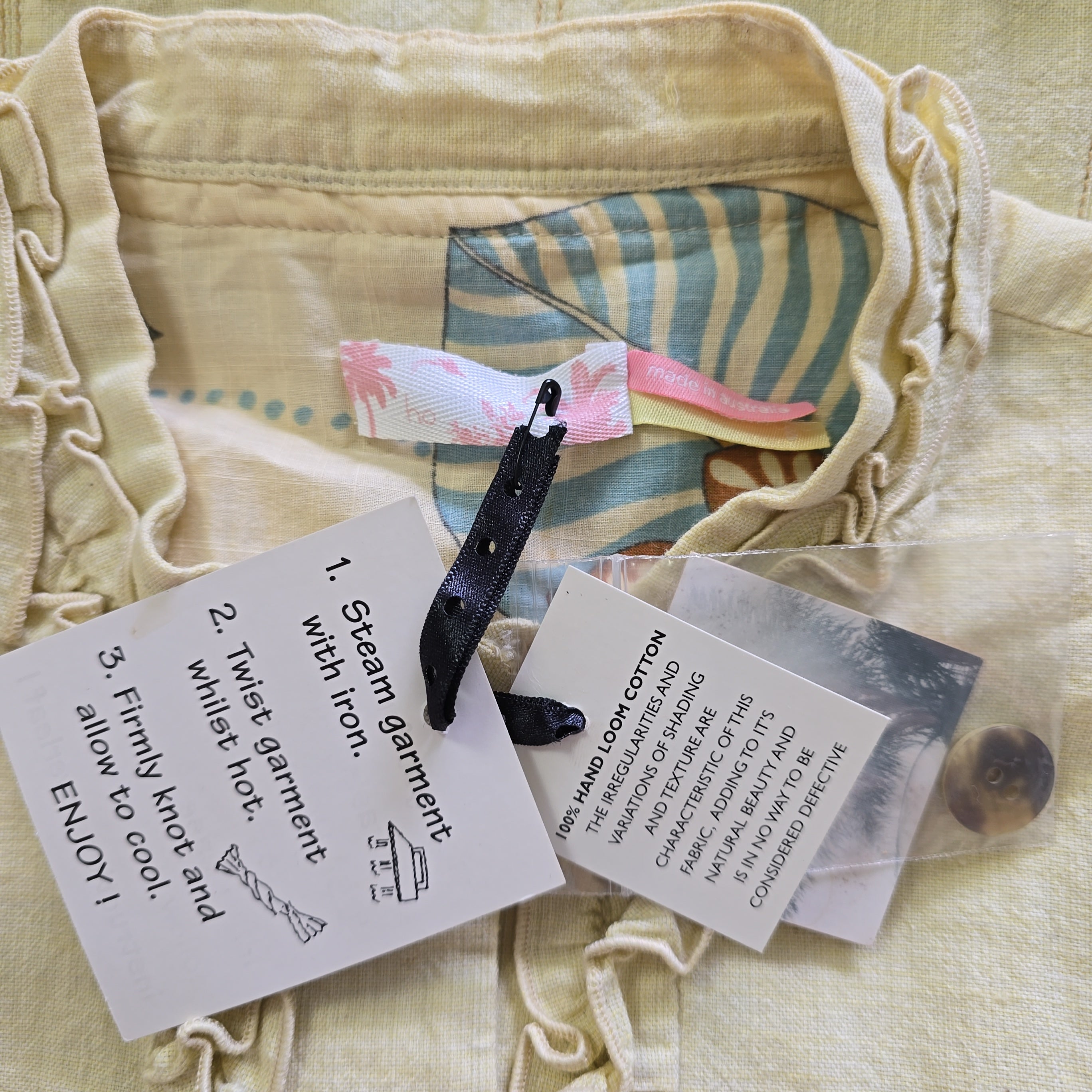 Textile with steam ironing instructions and tools on a textured fabric background