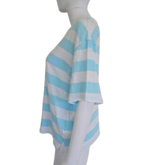 Mannequin arm with blue and white striped fabric on a plain background