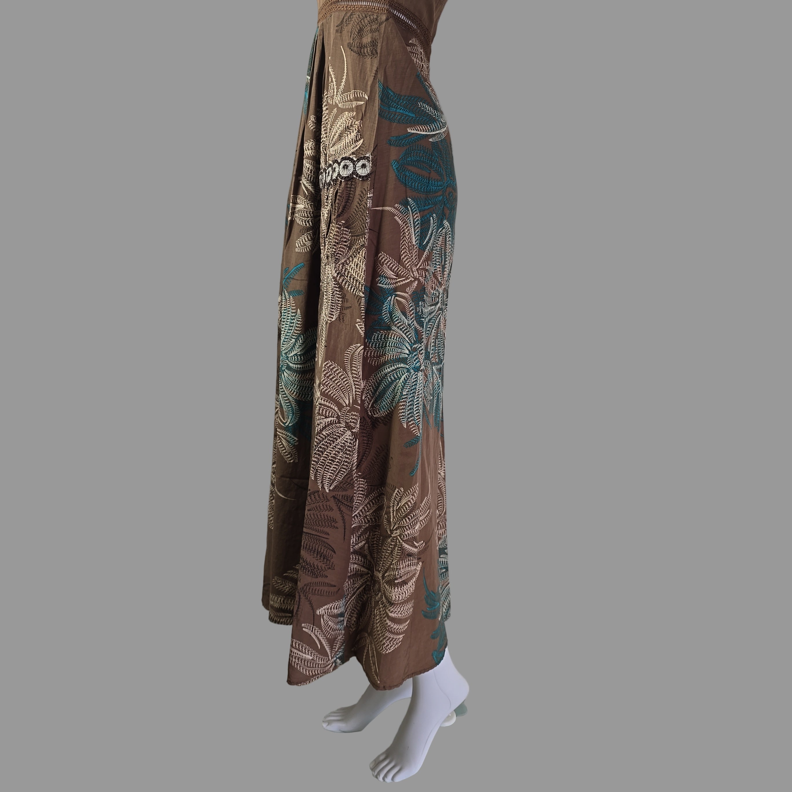 Folded floral-patterned garment on a white surface with tiled wall in the background