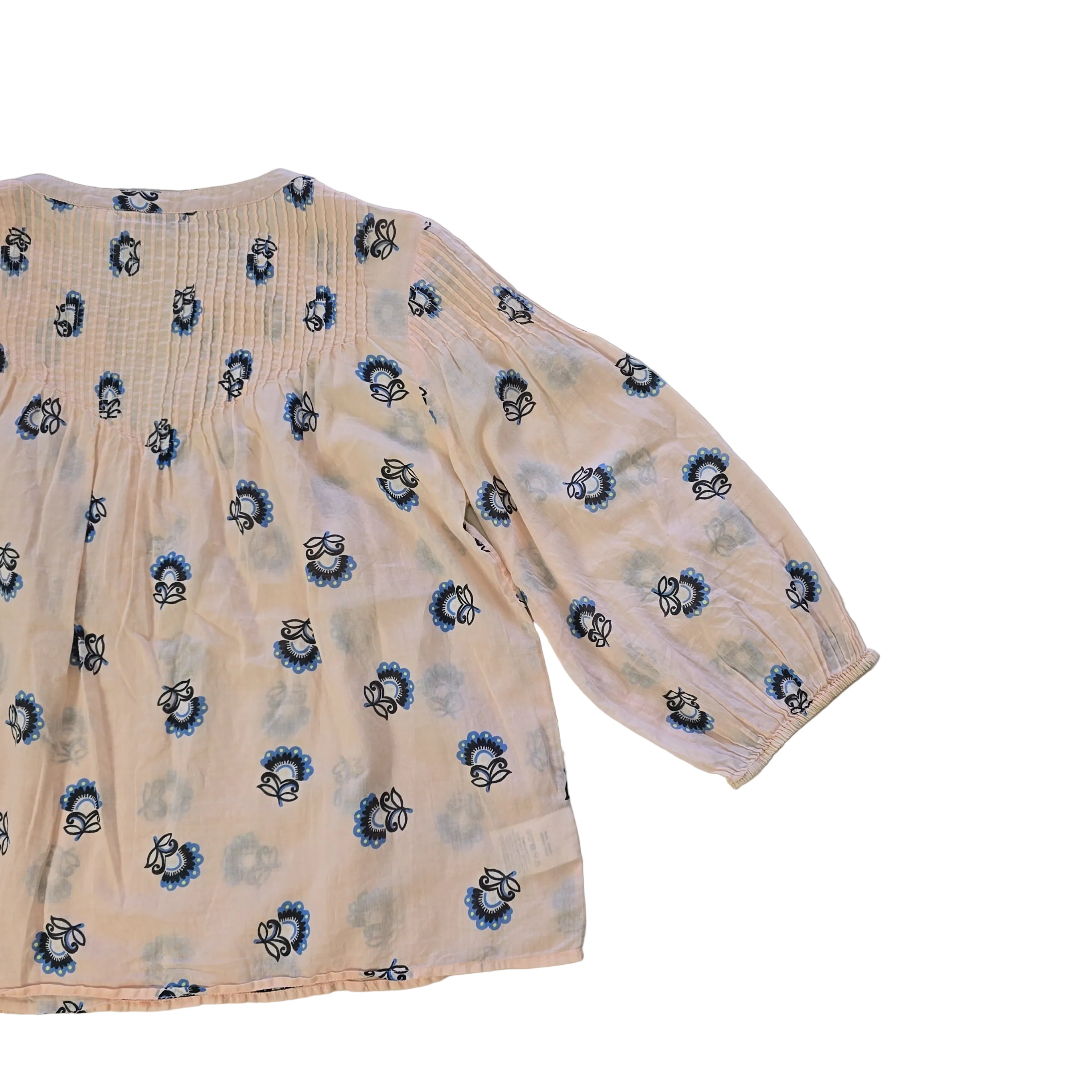 Floral-patterned flowy top on a light background