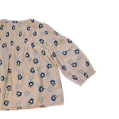 Floral-patterned flowy top on a light background