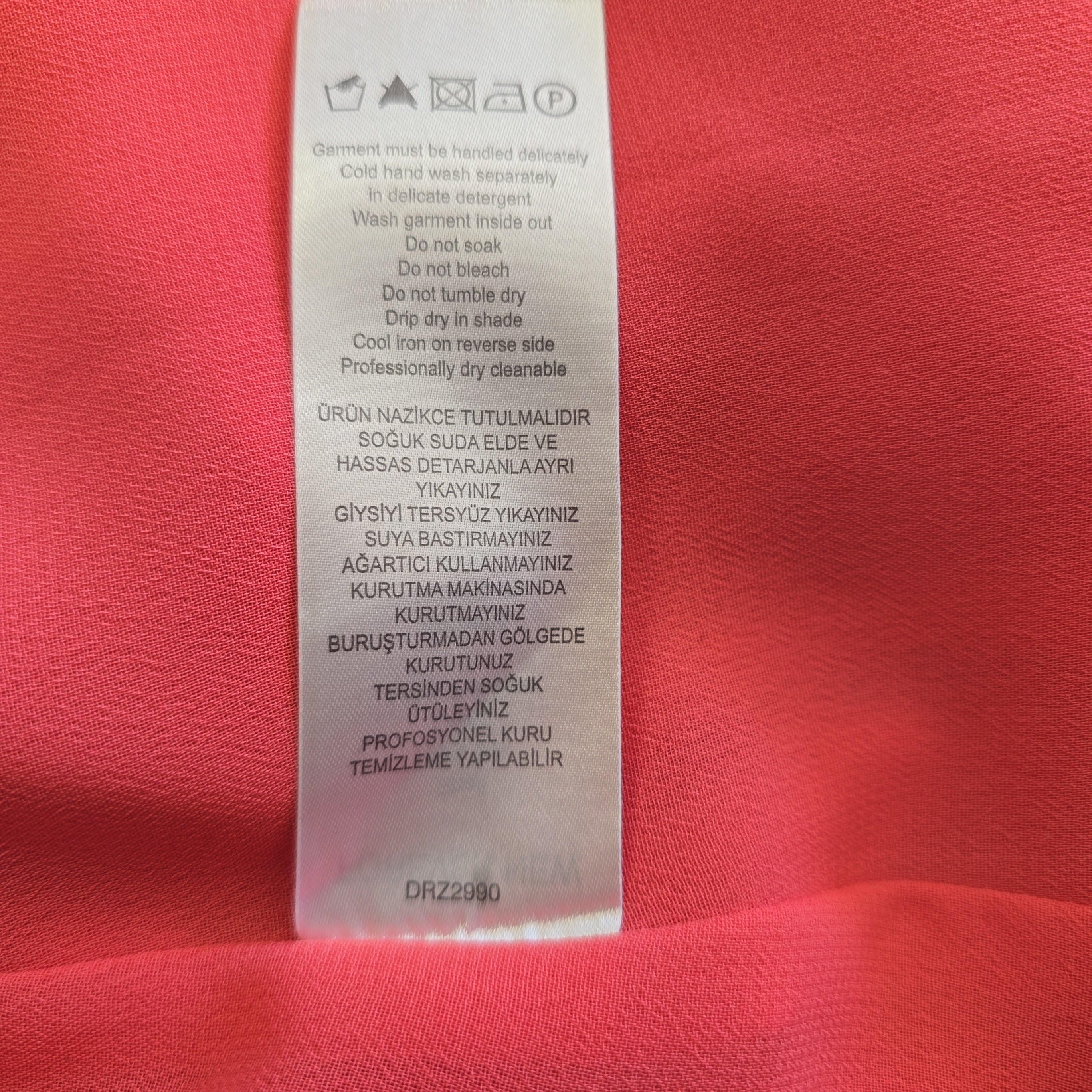 Clothing label on a red fabric background