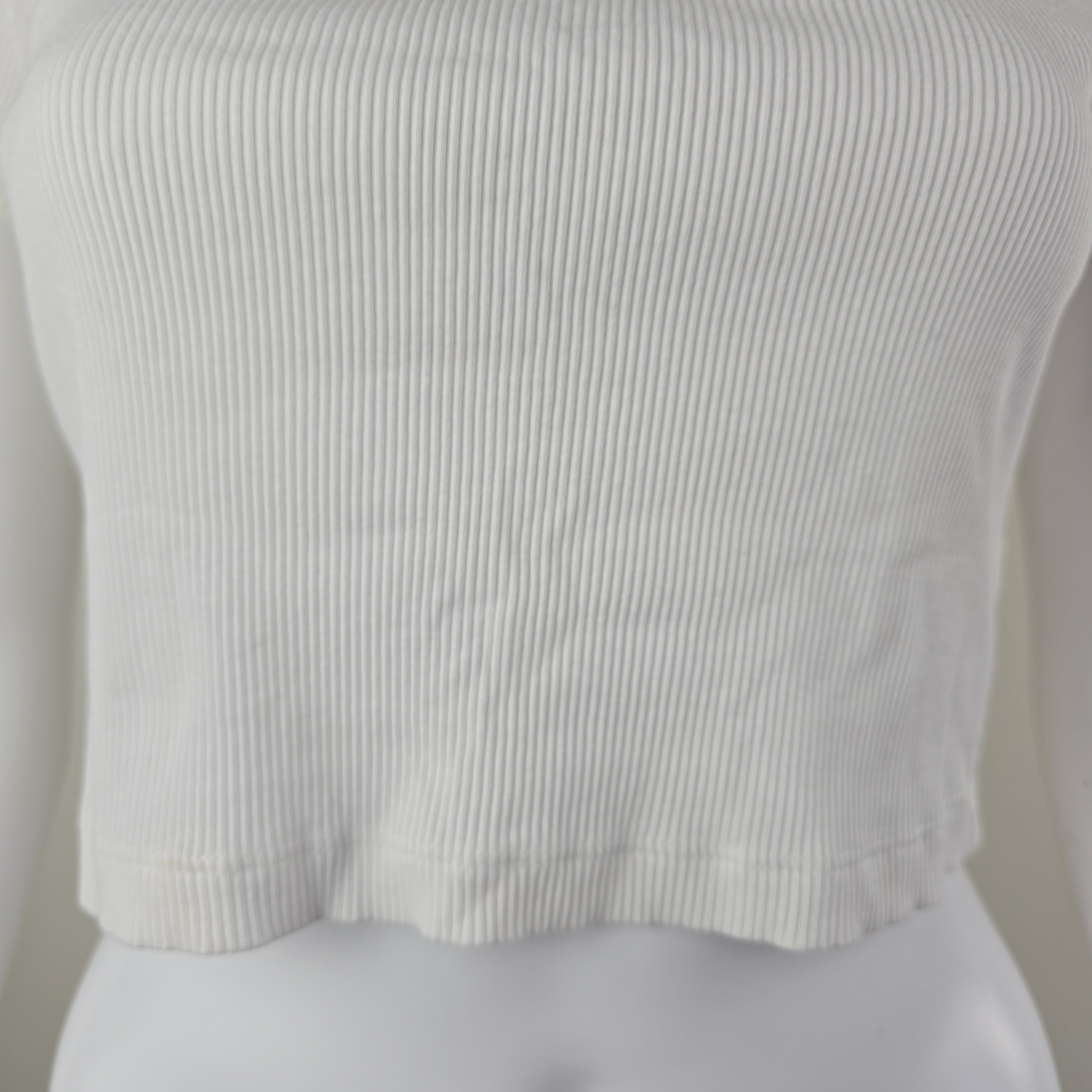 Close-up of a white shirt with thin stripes on a plain background