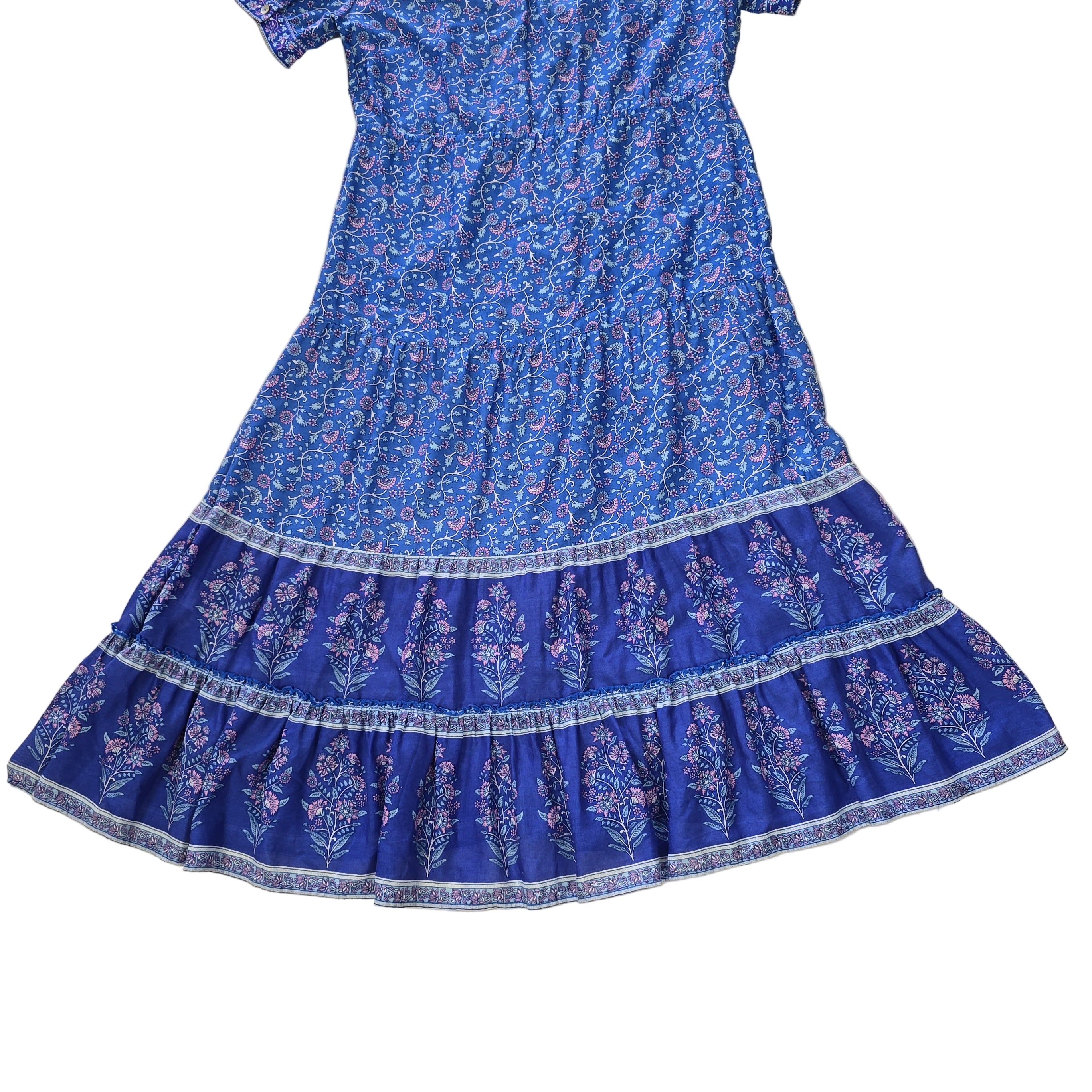 Blue floral dress with a ruffled hem on a tiled floor