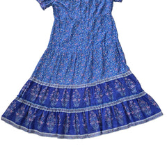 Blue floral dress with a ruffled hem on a tiled floor