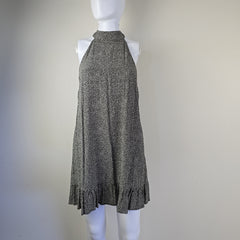 Grey and white spotted patterned dress on a light background