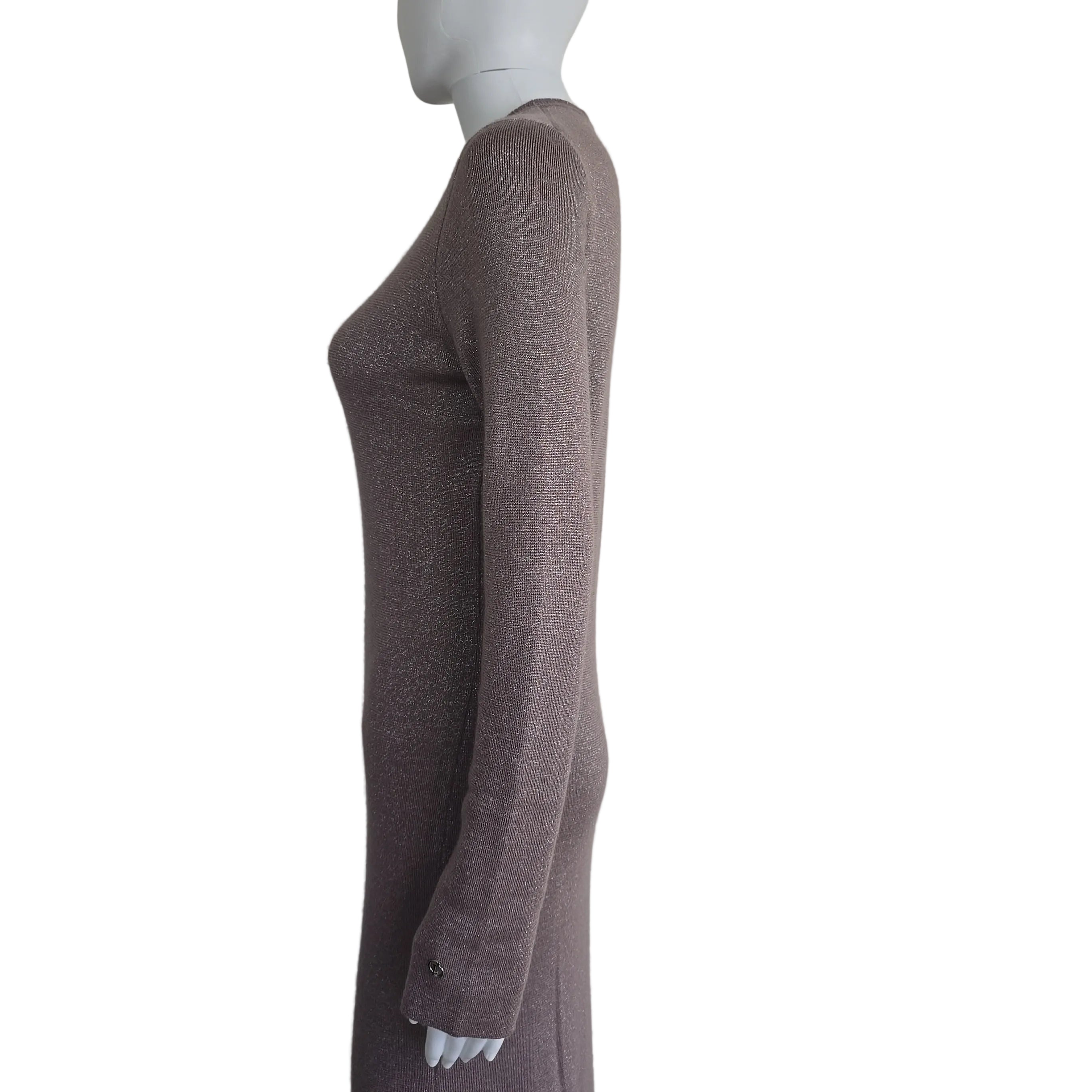 Plum coloured dress with silver details on a light background