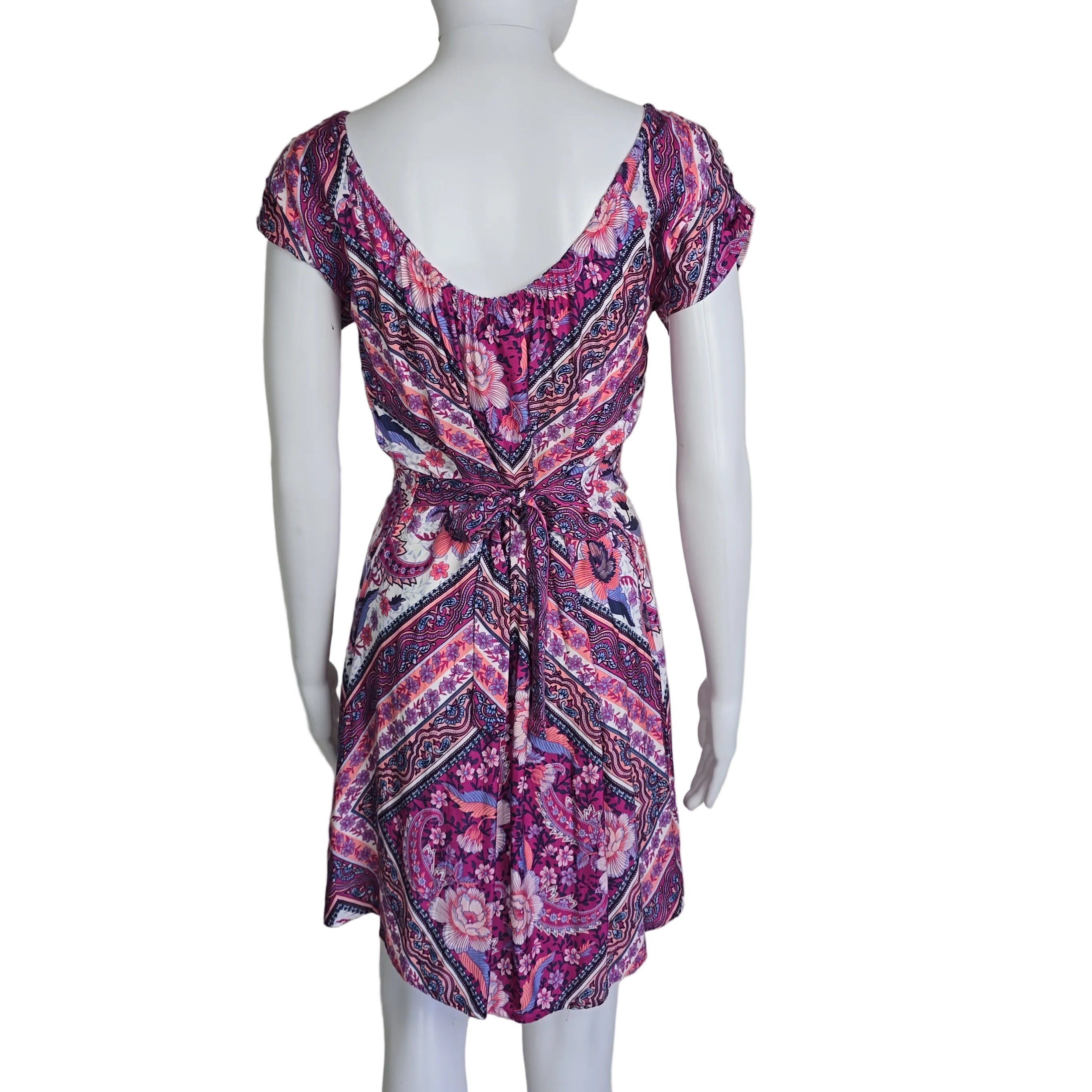 Mannequin wearing a patterned dress with a plain background