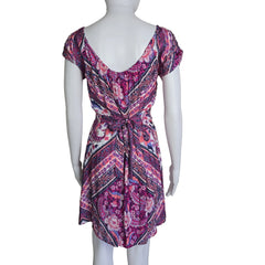 Mannequin wearing a patterned dress with a plain background