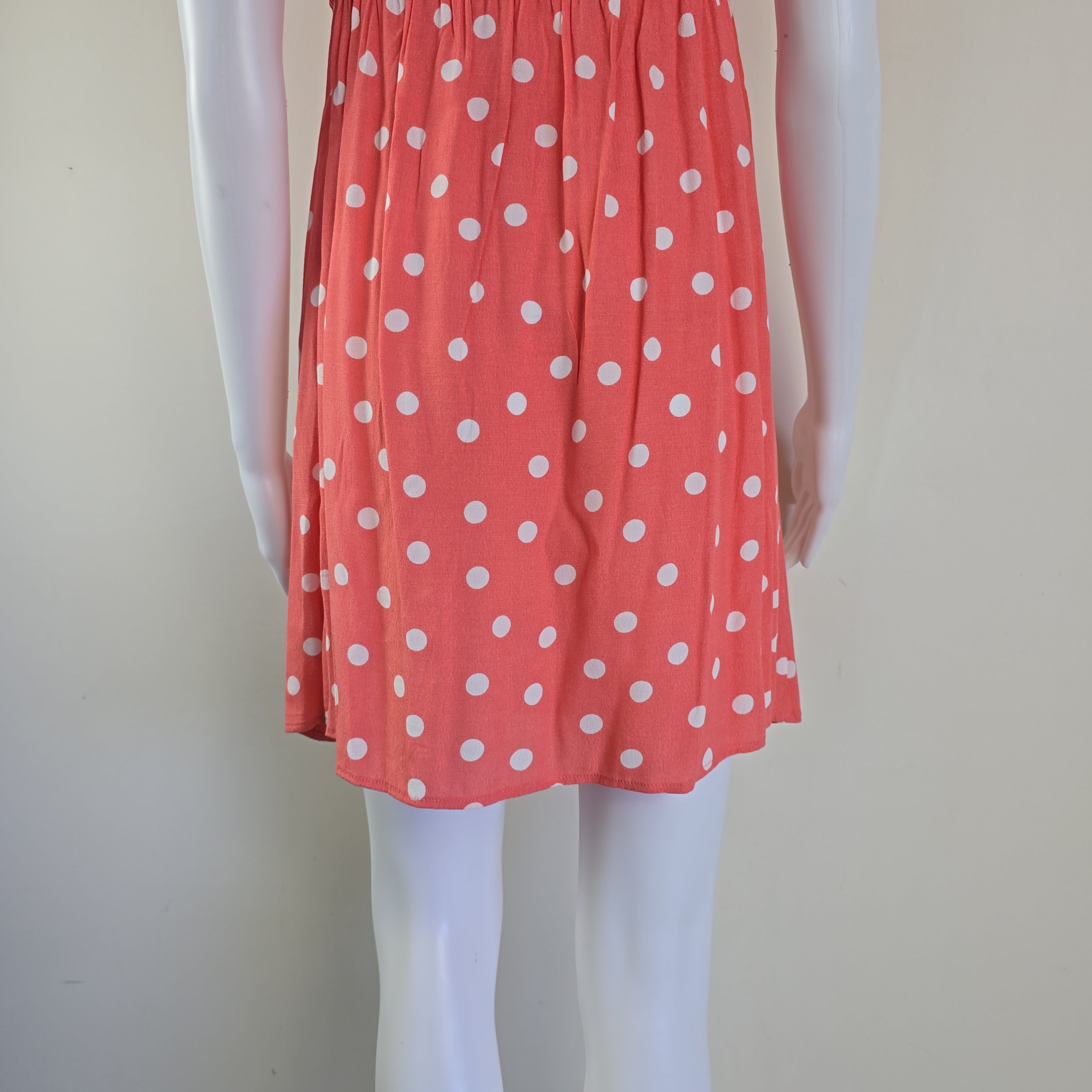 Red fabric with white polka dots on a white background