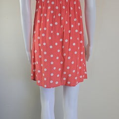 Red fabric with white polka dots on a white background