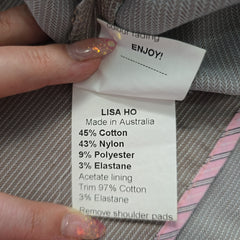 Fabric label with 'Lisa Ho' details on a textured fabric background