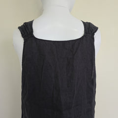 Black top on a mannequin against a beige background