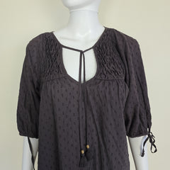 Brown textured top on a mannequin against a beige background