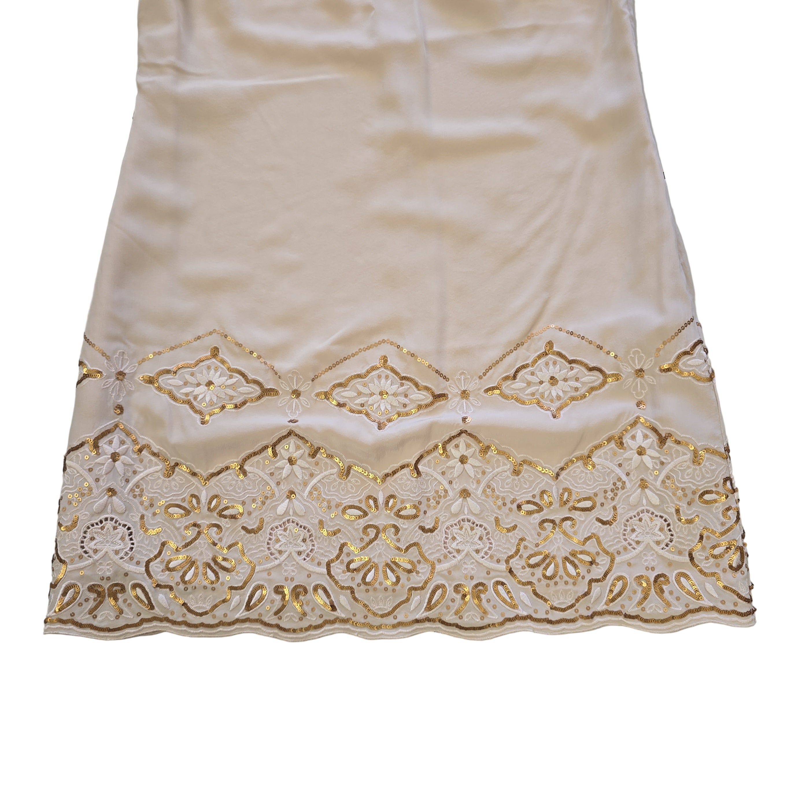 White fabric with gold lace trim on a light background
