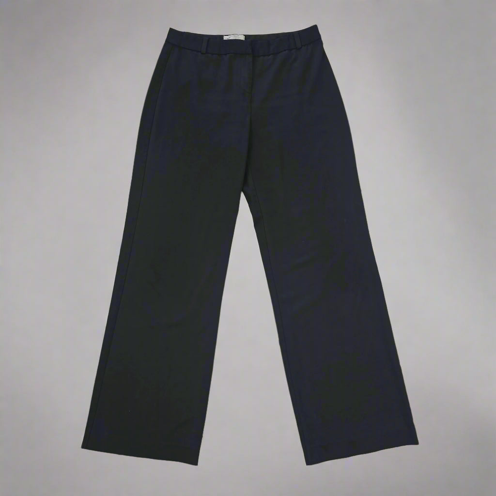 Black pants on a tiled floor