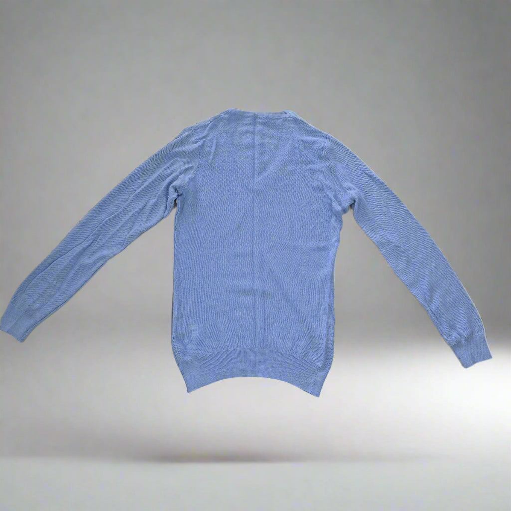 Blue long-sleeve shirt on a tiled floor